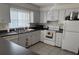 Simple kitchen with white cabinets and appliances at 11511 113Th St # 13H, Largo, FL 33778