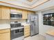 Kitchen area with stainless steel refrigerator and stove at 11511 113Th St # 13H, Largo, FL 33778