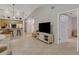 Living room with beige sofa and flat screen TV at 11511 113Th St # 13H, Largo, FL 33778