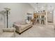 Living room with sofa, TV, and view into kitchen and hallway at 11511 113Th St # 13H, Largo, FL 33778