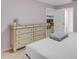 Main bedroom with dresser and view into living area at 11511 113Th St # 13H, Largo, FL 33778