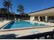 Community swimming pool with lounge chairs at 11511 113Th St # 13H, Largo, FL 33778