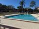 Community swimming pool with lounge chairs at 11511 113Th St # 13H, Largo, FL 33778