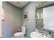 Small half bathroom with a pedestal sink and decorative mirror at 1200 Gulf Blvd # 204, Clearwater Beach, FL 33767