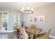 Elegant dining room with a rustic wood table and chandelier at 1200 Gulf Blvd # 204, Clearwater Beach, FL 33767