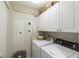 Laundry room with washer, dryer, and ample cabinet storage at 1200 Gulf Blvd # 204, Clearwater Beach, FL 33767