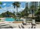Relaxing pool area with lounge chairs and palm trees at 1200 Gulf Blvd # 204, Clearwater Beach, FL 33767
