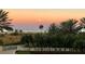 Stunning sunset view over the ocean and palm trees at 1200 Gulf Blvd # 204, Clearwater Beach, FL 33767