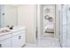 Elegant bathroom with white cabinets, marble tile, and a spacious shower at 12269 New Tranquility Path, Venice, FL 34293