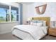 Bright bedroom featuring a plush bed and large window with garden view at 12269 New Tranquility Path, Venice, FL 34293