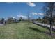 Fenced dog park with grassy area, waste disposal, and walking path at 12269 New Tranquility Path, Venice, FL 34293