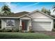 One-story home with gray siding, red door, and two-car garage at 12269 New Tranquility Path, Venice, FL 34293