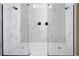 Large walk-in shower with marble tile and dual shower heads at 12269 New Tranquility Path, Venice, FL 34293