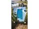 Community pool and spa with lounge chairs and shade structures at 1604 Boswell Ln, New Port Richey, FL 34655