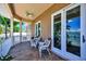 Relaxing balcony overlooking the water with tiled floor and comfy chairs at 16301 Redington Dr, Redington Beach, FL 33708
