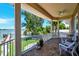 Waterfront balcony with wicker chairs and tile flooring at 16301 Redington Dr, Redington Beach, FL 33708