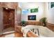 Bathroom with shower, soaking tub, and window at 16301 Redington Dr, Redington Beach, FL 33708