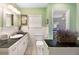 Clean bathroom with dark countertops and white cabinets at 16301 Redington Dr, Redington Beach, FL 33708
