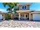 Two-story home with double doors and a brick driveway at 16301 Redington Dr, Redington Beach, FL 33708