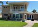 Two-story house with backyard patio, landscaping, and a detached garage at 16301 Redington Dr, Redington Beach, FL 33708