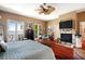 Main bedroom with water views, fireplace, and hardwood floors at 16301 Redington Dr, Redington Beach, FL 33708