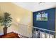 Upstairs hallway with hardwood floors and a view to the lower level at 16301 Redington Dr, Redington Beach, FL 33708