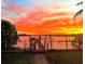 Scenic waterfront view at sunset with private dock at 16301 Redington Dr, Redington Beach, FL 33708