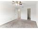 Well-lit bedroom with ceiling fan, carpet, and ample closet space at 200 Country Club Dr # 802, Largo, FL 33771