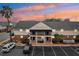 Two-story building exterior at sunset, featuring parking and landscaping at 200 Country Club Dr # 802, Largo, FL 33771
