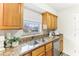 Kitchen with granite countertops, wood cabinets, and stainless steel appliances at 200 Country Club Dr # 802, Largo, FL 33771
