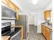 Open concept kitchen boasting stainless steel appliances and wood cabinets at 200 Country Club Dr # 802, Largo, FL 33771