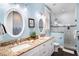 This bathroom offers dual sinks with granite countertops and a glass shower, perfect for shared use at 206 Church Ave, Bradenton Beach, FL 34217