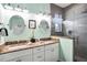 Beautiful bathroom featuring double sinks, granite counters and a glass shower at 206 Church Ave, Bradenton Beach, FL 34217