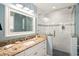 Stylish bathroom with granite counters, vanity and a glass-enclosed shower at 206 Church Ave, Bradenton Beach, FL 34217