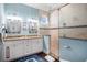 This bathroom has dual sinks with granite countertops and a glass shower, creating a functional space at 206 Church Ave, Bradenton Beach, FL 34217