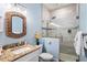 This stylish bathroom features a granite countertop vanity and a glass shower with a rain shower head at 206 Church Ave, Bradenton Beach, FL 34217