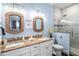 Stylish bathroom with dual sinks, granite countertops, and a glass-enclosed shower at 206 Church Ave, Bradenton Beach, FL 34217