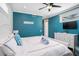Bedroom with a bright blue accent wall, a TV, and a dresser, providing a relaxing atmosphere at 206 Church Ave, Bradenton Beach, FL 34217