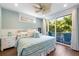 Bedroom with white bedding, light blue walls, and private balcony access at 206 Church Ave, Bradenton Beach, FL 34217