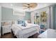 Bright bedroom with a ceiling fan, balcony access, and white furnishings at 206 Church Ave, Bradenton Beach, FL 34217