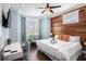 Relax in this bedroom with wood floors, a TV, ceiling fan, and a bay window for natural light at 206 Church Ave, Bradenton Beach, FL 34217