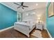 Bright bedroom with white furniture, teal walls, and ceiling fan at 206 Church Ave, Bradenton Beach, FL 34217