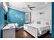 Bright bedroom featuring a queen bed, a white desk, and a calming turquoise wall at 206 Church Ave, Bradenton Beach, FL 34217