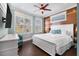 Comfortable bedroom featuring wood-paneled accent wall and ample natural light at 206 Church Ave, Bradenton Beach, FL 34217