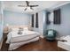 This bedroom has a plush chair, wood floors, and a comfortable bed for a great night's sleep at 206 Church Ave, Bradenton Beach, FL 34217