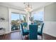 Bright dining area with balcony access, modern light fixture, and comfortable seating at 206 Church Ave, Bradenton Beach, FL 34217