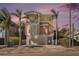 Charming three-story coastal home featuring a balcony, rounded windows, and a garage at 206 Church Ave, Bradenton Beach, FL 34217
