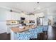 Modern kitchen with white cabinets, granite countertops, stainless steel appliances, and island seating at 206 Church Ave, Bradenton Beach, FL 34217