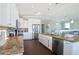 Bright kitchen featuring stainless steel appliances, granite countertops and an island bar at 206 Church Ave, Bradenton Beach, FL 34217