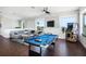 Living room with a pool table, arcade game and stylish furniture at 206 Church Ave, Bradenton Beach, FL 34217